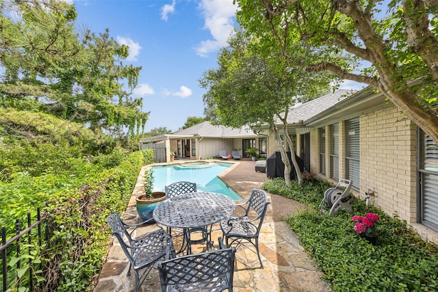 view of swimming pool featuring a patio and outdoor dining area