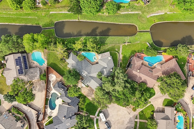 aerial view of a pool area and a large body of water