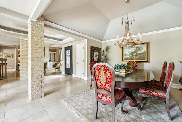 dining room with decorative columns, a chandelier, a raised ceiling, tile patterned flooring, and baseboards