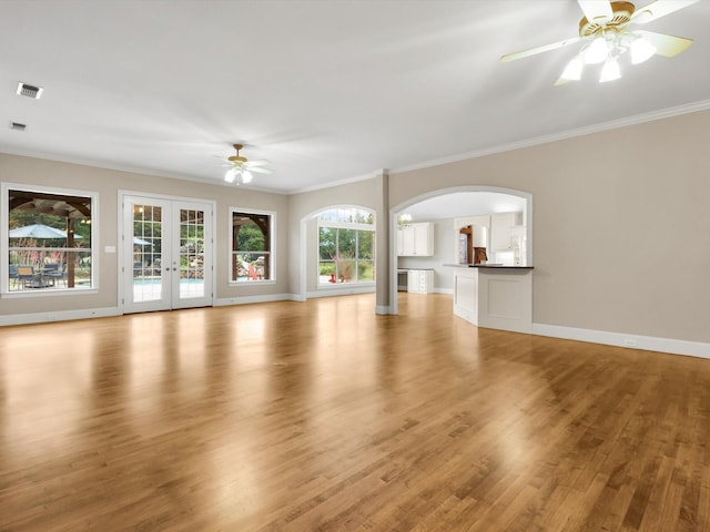 901 Saint James Dr, Fairview, TX 75069 - unfurnished living room with a ceiling fan, arched walkways, crown molding, light wood finished floors, and french doors