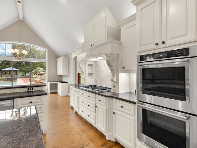 901 Saint James Dr, Fairview, TX 75069 - kitchen with stainless steel appliances, a chandelier, tasteful backsplash, light wood-style floors, and dark stone counters