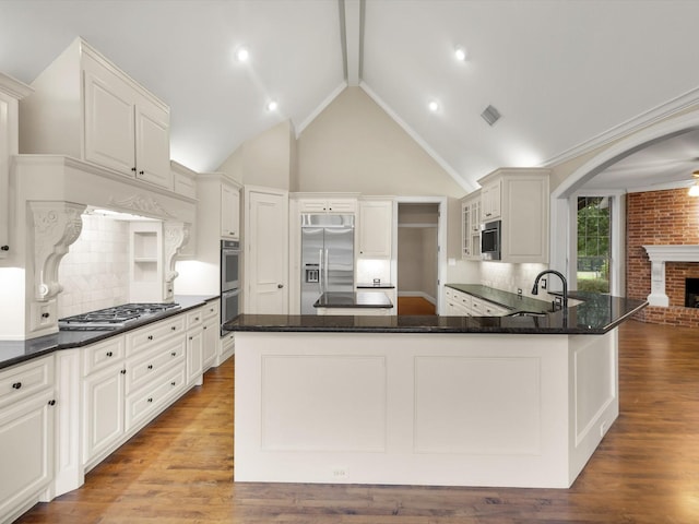 901 Saint James Dr, Fairview, TX 75069 - kitchen featuring appliances with stainless steel finishes, a sink, a fireplace, and backsplash