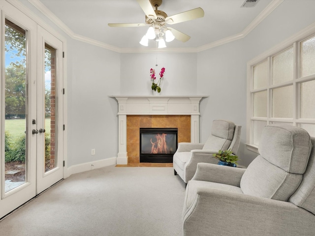 901 Saint James Dr, Fairview, TX 75069 - carpeted living room with ornamental molding, a ceiling fan, a tile fireplace, and baseboards