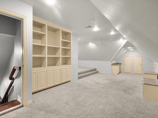 901 Saint James Dr, Fairview, TX 75069 - bonus room featuring carpet, vaulted ceiling, ceiling fan, stairway, and a textured ceiling