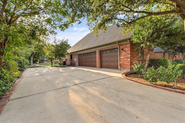 901 Saint James Dr, Fairview, TX 75069 - view of home's exterior with driveway, an attached garage, brick siding, and roof with shingles
