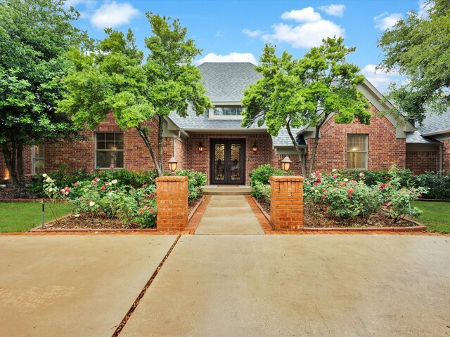 901 Saint James Dr, Fairview, TX 75069 - view of front of home with french doors, a shingled roof, and brick siding