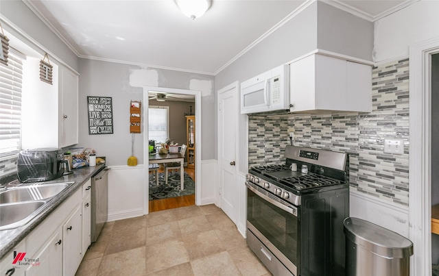 236 Leland Dr, Shreveport, LA 71105 - kitchen featuring appliances with stainless steel finishes, a sink, white cabinetry, backsplash, and crown molding