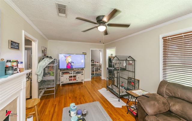 236 Leland Dr, Shreveport, LA 71105 - living area with ceiling fan, wood finished floors, a textured ceiling, and ornamental molding