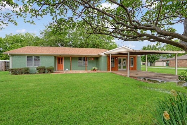 200 Herberta St, Pottsboro, TX 75076 - single story home with french doors, a front yard, brick siding, a shingled roof, and a carport