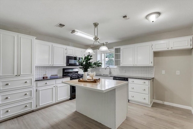 200 Herberta St, Pottsboro, TX 75076 - kitchen with black appliances, tasteful backsplash, white cabinetry, and light wood-style flooring