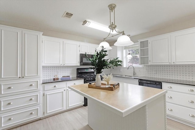 200 Herberta St, Pottsboro, TX 75076 - kitchen with a sink, black appliances, backsplash, and white cabinets