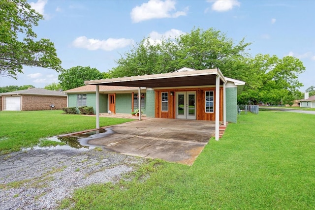 200 Herberta St, Pottsboro, TX 75076 - view of front of property featuring french doors, a carport, a front lawn, and driveway