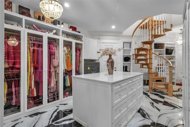 417 Windwood Ct, Mckinney, TX 75071 - spacious closet featuring a chandelier and light marble finish flooring