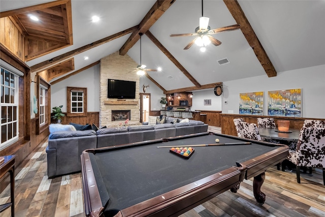 417 Windwood Ct, Mckinney, TX 75071 - recreation room with a ceiling fan, wainscoting, hardwood / wood-style floors, a stone fireplace, and wooden walls