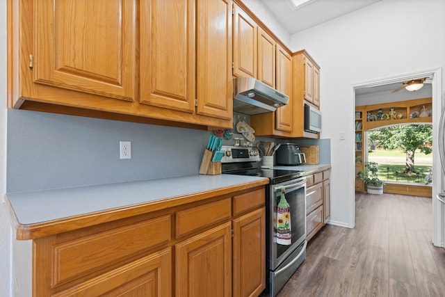2521 Trail Tree Ct, Burleson, TX 76028 - kitchen featuring electric stove, under cabinet range hood, white microwave, light countertops, and dark wood-style floors