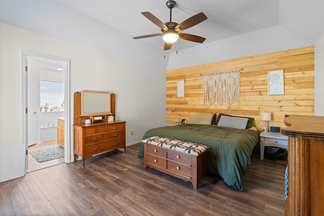 2521 Trail Tree Ct, Burleson, TX 76028 - bedroom with wood finished floors, wooden walls, connected bathroom, and ceiling fan