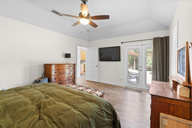 2521 Trail Tree Ct, Burleson, TX 76028 - bedroom featuring access to exterior, wood finished floors, vaulted ceiling, a textured ceiling, and baseboards