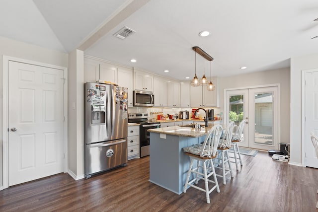 2521 Trail Tree Ct, Burleson, TX 76028 - kitchen with appliances with stainless steel finishes, a sink, a kitchen breakfast bar, white cabinets, and french doors