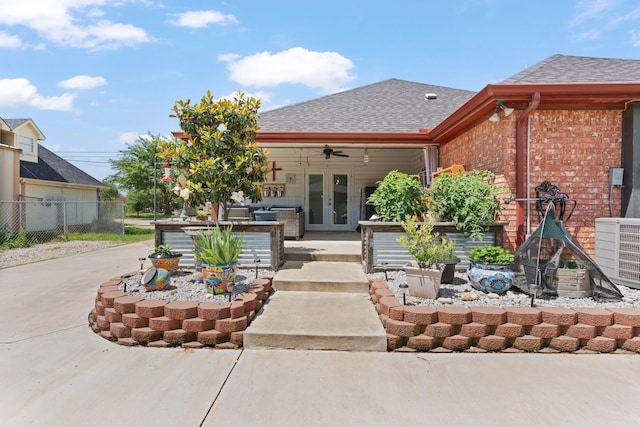 2521 Trail Tree Ct, Burleson, TX 76028 - view of front facade with french doors, brick siding, fence, roof with shingles, and a ceiling fan