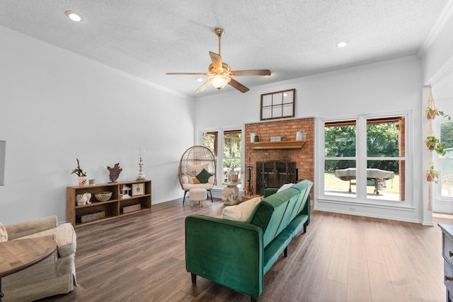 2521 Trail Tree Ct, Burleson, TX 76028 - living room featuring a textured ceiling, ceiling fan, plenty of natural light, crown molding, and a brick fireplace
