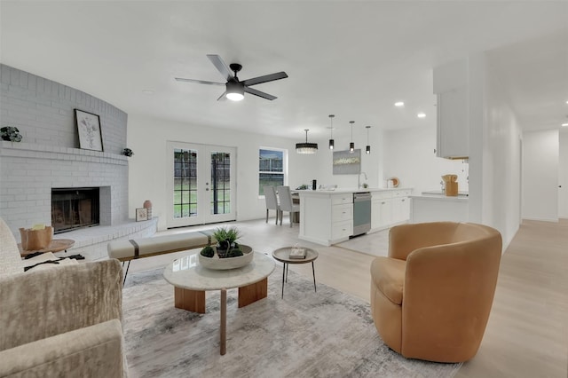 4608 Willow Elm Ct, Arlington, TX 76017 - living area with light wood-type flooring, a ceiling fan, recessed lighting, and a fireplace