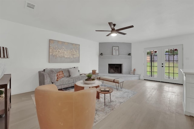 4608 Willow Elm Ct, Arlington, TX 76017 - living area with a ceiling fan, french doors, light wood-style flooring, and a fireplace