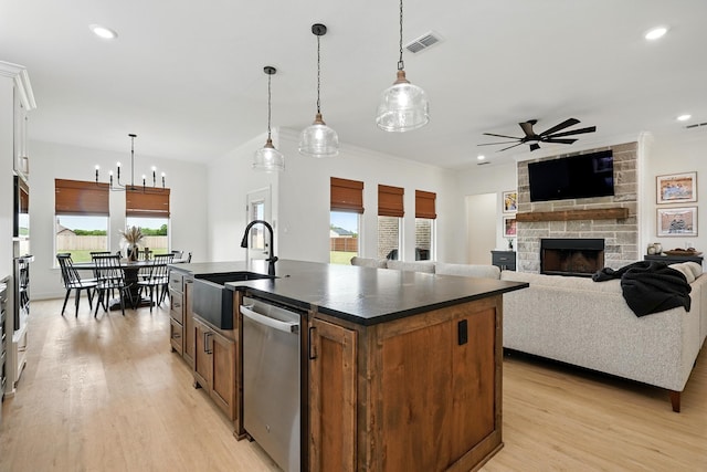 120 Crosswind Trl, Ovalo, TX 79541 - kitchen with appliances with stainless steel finishes, dark countertops, a sink, a ceiling fan, and light wood-style floors