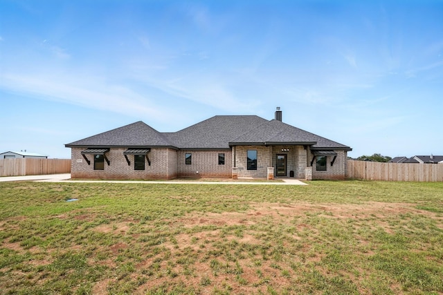 120 Crosswind Trl, Ovalo, TX 79541 - rear view of house featuring brick siding, a chimney, and roof with shingles