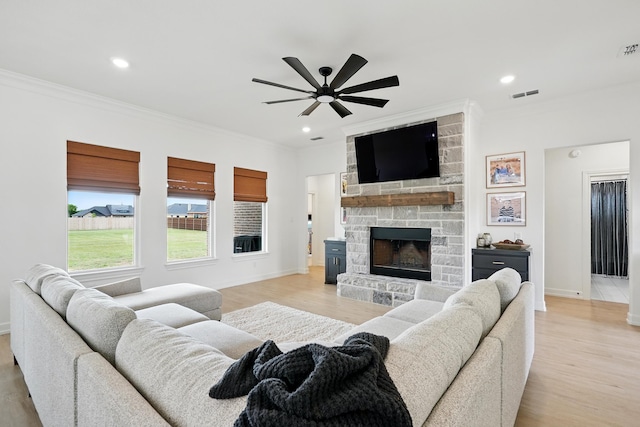 120 Crosswind Trl, Ovalo, TX 79541 - living area with crown molding, ceiling fan, a fireplace, light wood-style floors, and baseboards