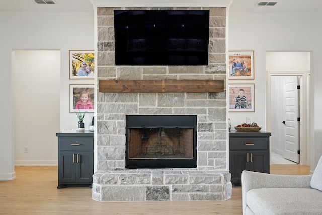 120 Crosswind Trl, Ovalo, TX 79541 - living room featuring ornamental molding, baseboards, light wood finished floors, and a stone fireplace