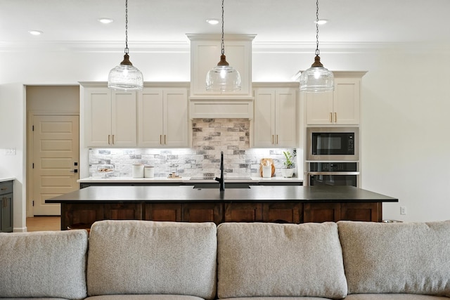 120 Crosswind Trl, Ovalo, TX 79541 - kitchen featuring stainless steel oven, backsplash, open floor plan, built in microwave, and ornamental molding