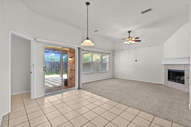 1060 Knightsbridge Dr, Frisco, TX 75036 - unfurnished living room with light colored carpet, a ceiling fan, a tile fireplace, baseboards, and vaulted ceiling
