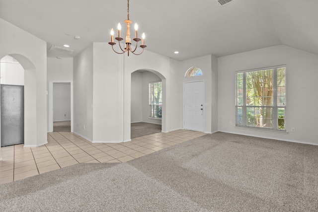 1060 Knightsbridge Dr, Frisco, TX 75036 - carpeted spare room with arched walkways, a chandelier, tile patterned floors, lofted ceiling, and baseboards