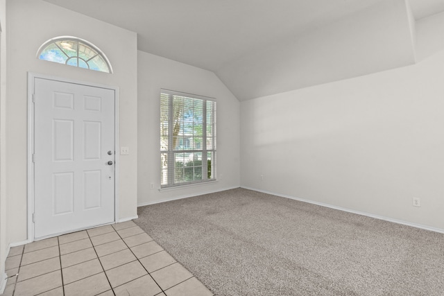 1060 Knightsbridge Dr, Frisco, TX 75036 - foyer entrance featuring lofted ceiling, light tile patterned floors, baseboards, and light carpet