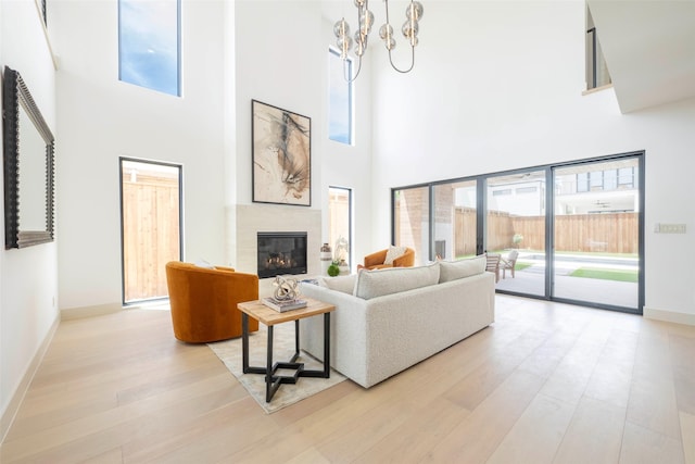 4435 Merrell Rd, Dallas, TX 75229 - living room with wood finished floors, a glass covered fireplace, and a high ceiling