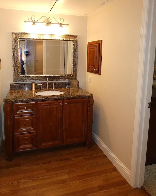 10534 Stone Canyon Rd Unit 111, Dallas, TX 75230 - bathroom with wood finished floors, vanity, and baseboards