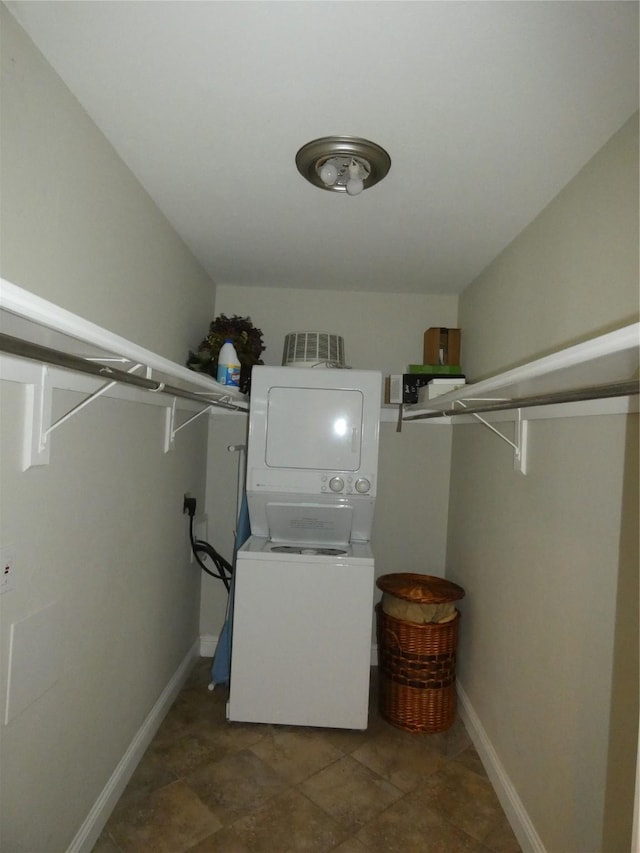 10534 Stone Canyon Rd Unit 111, Dallas, TX 75230 - laundry room featuring stacked washer / dryer and baseboards