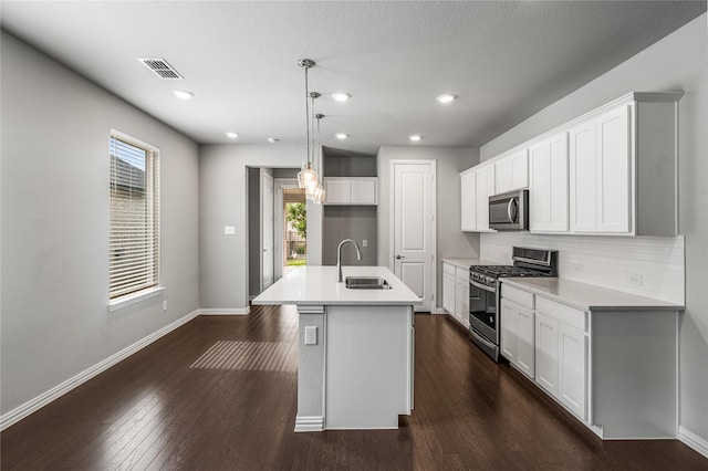 2545 Stella Ln, Northlake, TX 76247 - kitchen featuring stainless steel appliances, a sink, a kitchen island with sink, backsplash, and white cabinetry