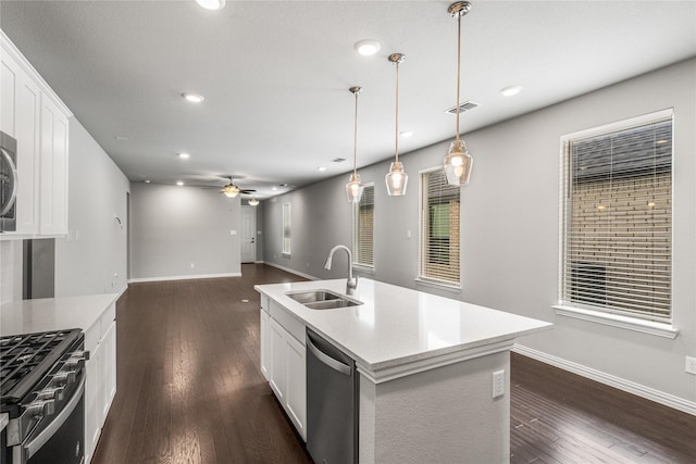 2545 Stella Ln, Northlake, TX 76247 - kitchen with a sink, stainless steel appliances, a ceiling fan, baseboards, and dark wood-style flooring