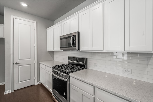 2545 Stella Ln, Northlake, TX 76247 - kitchen with stainless steel appliances, white cabinets, decorative backsplash, light stone counters, and recessed lighting