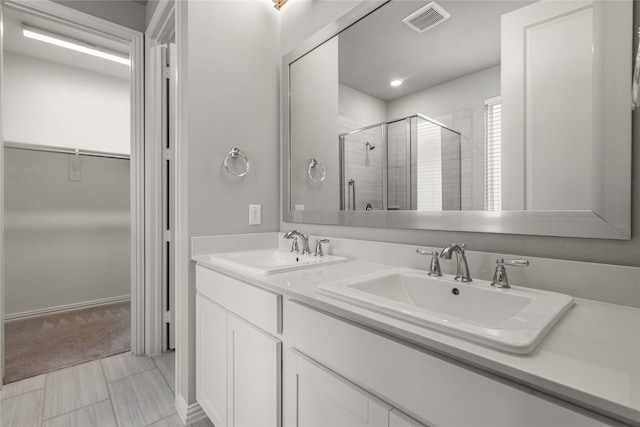 2545 Stella Ln, Northlake, TX 76247 - bathroom featuring a shower stall, a walk in closet, and double vanity