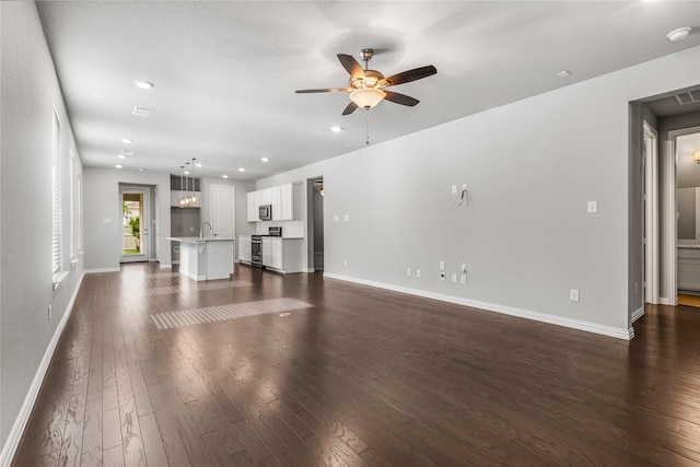 2545 Stella Ln, Northlake, TX 76247 - unfurnished living room with dark wood-style floors, baseboards, ceiling fan, a sink, and recessed lighting
