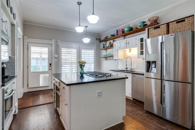 5206 Victor St, Dallas, TX 75214 - kitchen featuring stainless steel appliances, a sink, dark countertops, open shelves, and ornamental molding