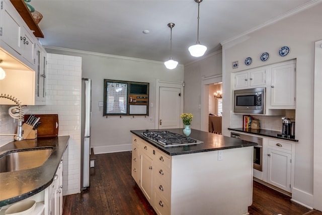 5206 Victor St, Dallas, TX 75214 - kitchen featuring appliances with stainless steel finishes, dark wood-style flooring, a sink, tasteful backsplash, and crown molding