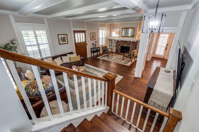 5206 Victor St, Dallas, TX 75214 - stairs featuring beam ceiling, wood finished floors, a fireplace, a chandelier, and crown molding