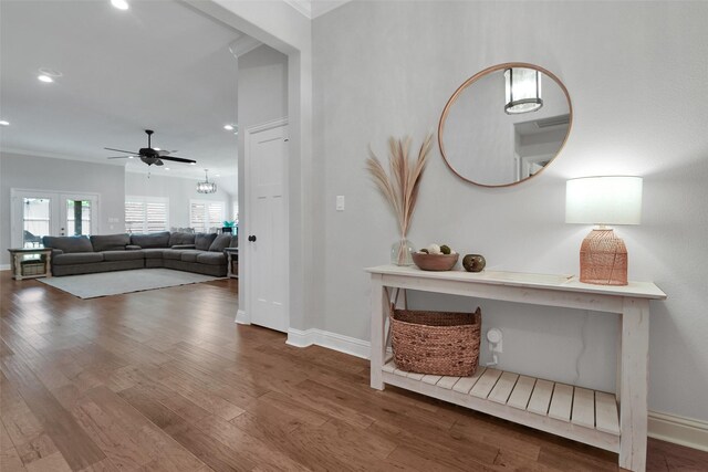 corridor featuring recessed lighting, baseboards, and wood finished floors