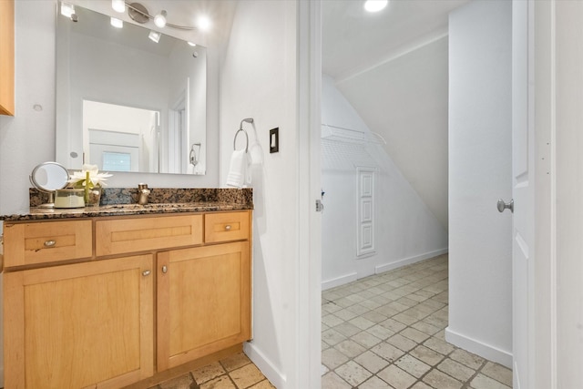 2544 Wedglea Dr, Dallas, TX 75211 - bathroom with vanity, vaulted ceiling, and baseboards