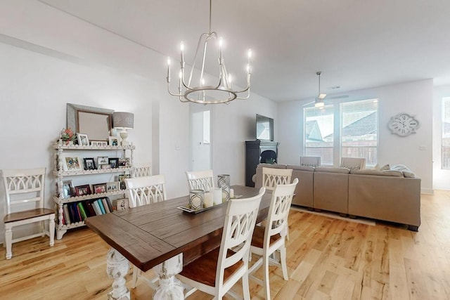 1033 Falls Rush Way, Royse City, TX 75189 - dining area with light wood-style flooring, a chandelier, and ceiling fan