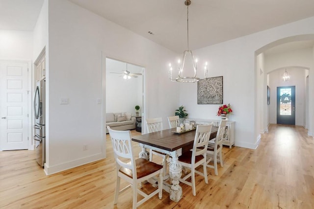 1033 Falls Rush Way, Royse City, TX 75189 - dining room with arched walkways, light wood finished floors, baseboards, ceiling fan, and a chandelier