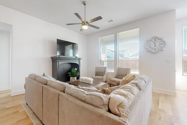 1033 Falls Rush Way, Royse City, TX 75189 - living room with light wood-style floors, plenty of natural light, a fireplace, and a ceiling fan
